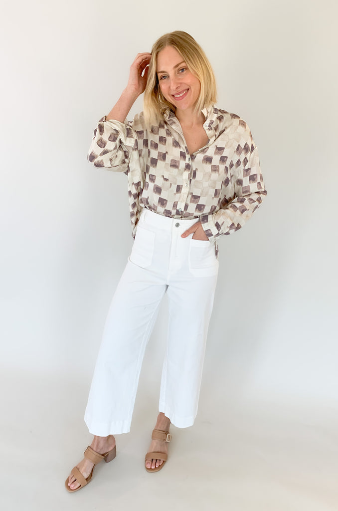 This Wisteria Button Front Faded Check Blouse features a unique faded checkered pattern for a subtle stylish look! Crafted from a silky material, it is designed with long sleeves and buttons for added comfort and convenience! Perfect for a polished yet effortless look for work or for dinner at night!