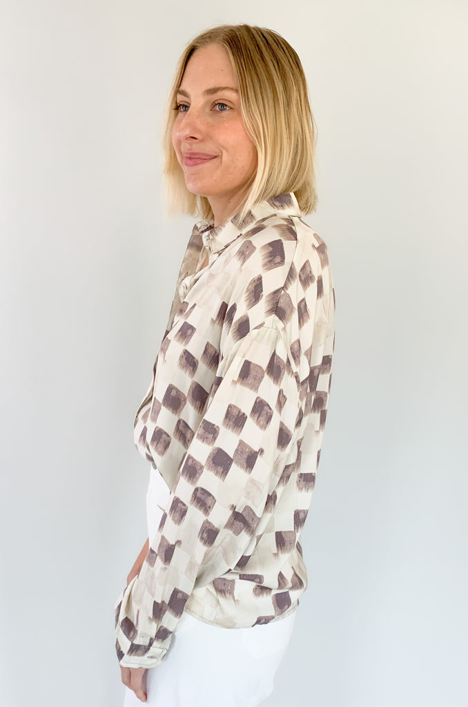 This Wisteria Button Front Faded Check Blouse features a unique faded checkered pattern for a subtle stylish look! Crafted from a silky material, it is designed with long sleeves and buttons for added comfort and convenience! Perfect for a polished yet effortless look for work or for dinner at night!