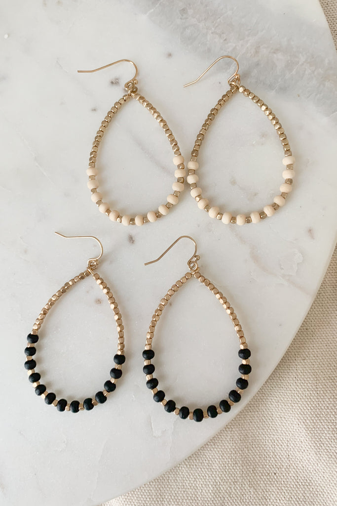 Accessorize with these handcrafted Wood Bead Gold Teardrop Earrings! Exquisitely designed with a bright gold finish, this unique accessory will add the perfect touch to any outfit. They are lightweight and comfortable too. 