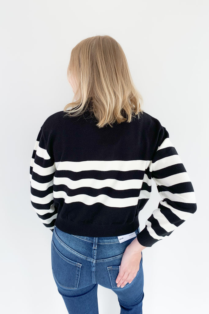 The Charlotte Avery Yang Black & White V Neck Sweater is so classic! Black and white stripes never go out of style, especially when paired with this trendy silhouette. It's collared, semi-cropped, and ultra soft. We love anything cashmere too, so this sweater is definitely one worth scooping up. 