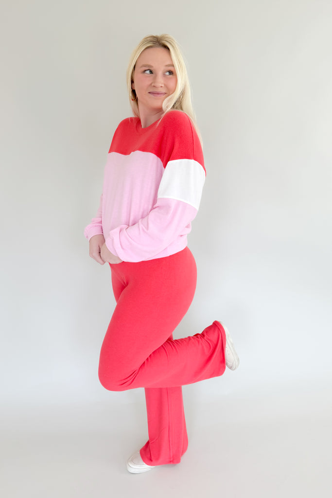 Amp up your casual look with the [Z SUPPLY] Cross Over Flare Pant in Candy Red! This stylish pant features an ultra soft fabric, elastic waistband with criss cross detail, and color block accents for added flair. Enjoy complete comfort with a splash of fun with this Z SUPPLY pant! 