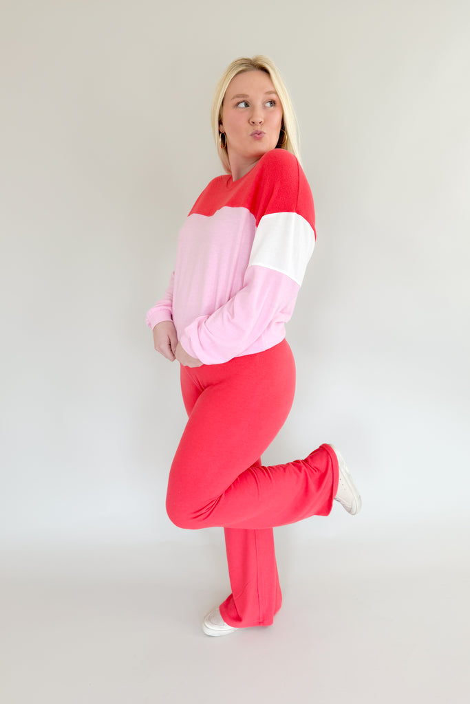 Amp up your casual look with the [Z SUPPLY] Cross Over Flare Pant in Candy Red! This stylish pant features an ultra soft fabric, elastic waistband with criss cross detail, and color block accents for added flair. Enjoy complete comfort with a splash of fun with this Z SUPPLY pant! 