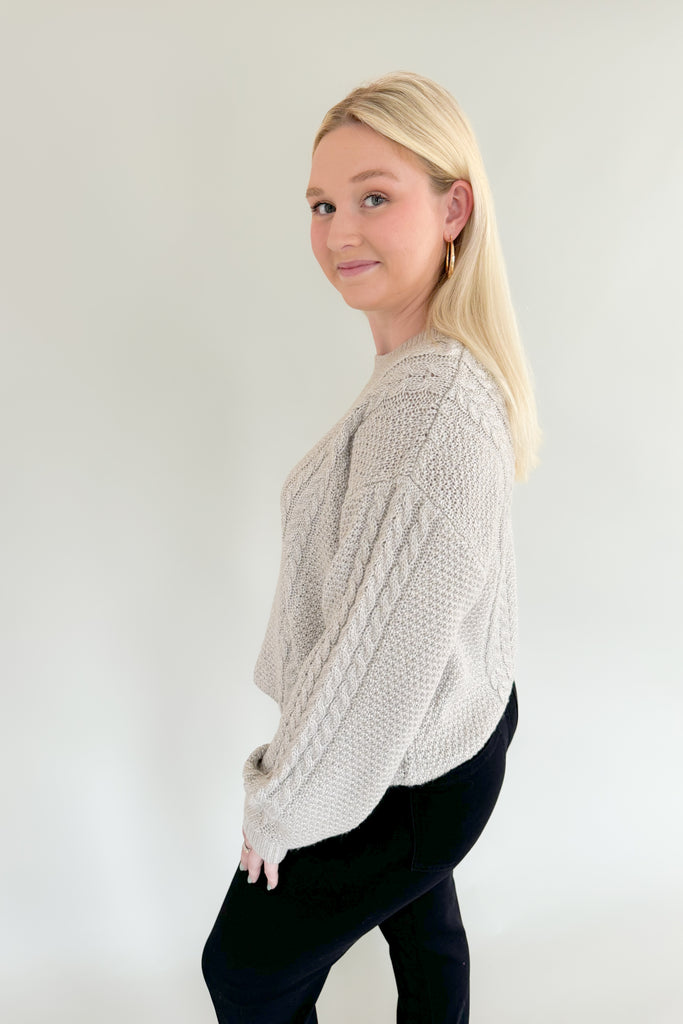 Add some sparkle into your wardrobe this season with this new chunky sweater, made of metallic yarns. The luxe [Z SUPPLY] Eternal Metallic Cable Sweater in Dove has a drop shoulder, crew neckline, and relaxed sleeves that bloussant. This sweater is just as perfect for a night out or a day running errands.