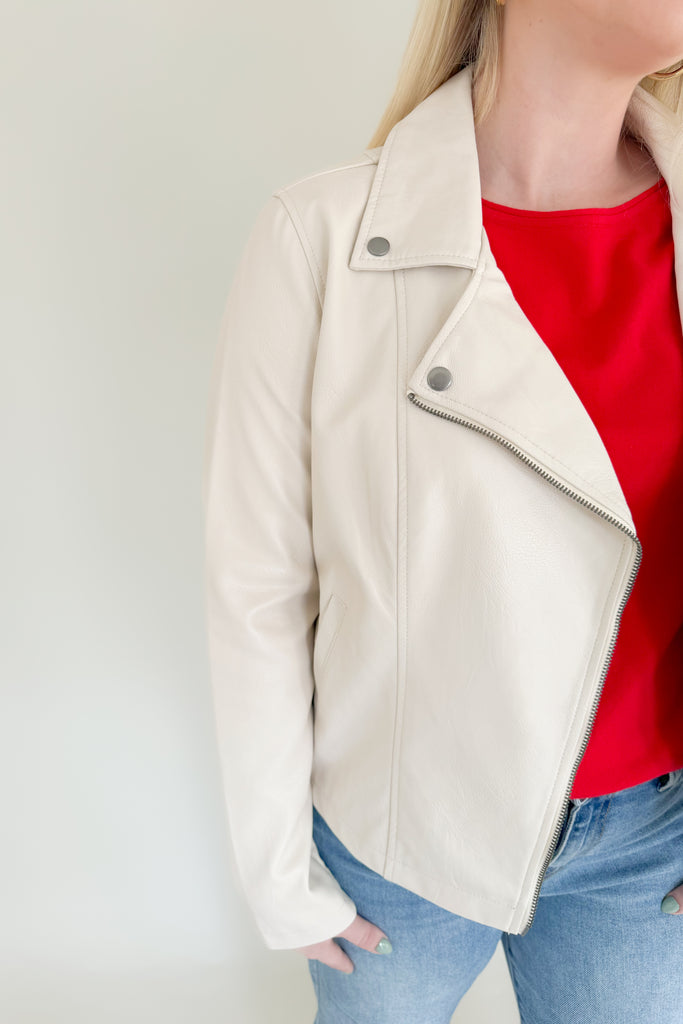 Add an instant edginess to any look with this faux leather statement jacket. The fully lined [Z SUPPLY] Trina Moto Jacket in Ecru is made using Z SUPPLYS vegan faux leather fabric and features an asymmetrical zip front, zippered sleeves, and functional welt pockets for a cool look you'll wanna wear all season. 