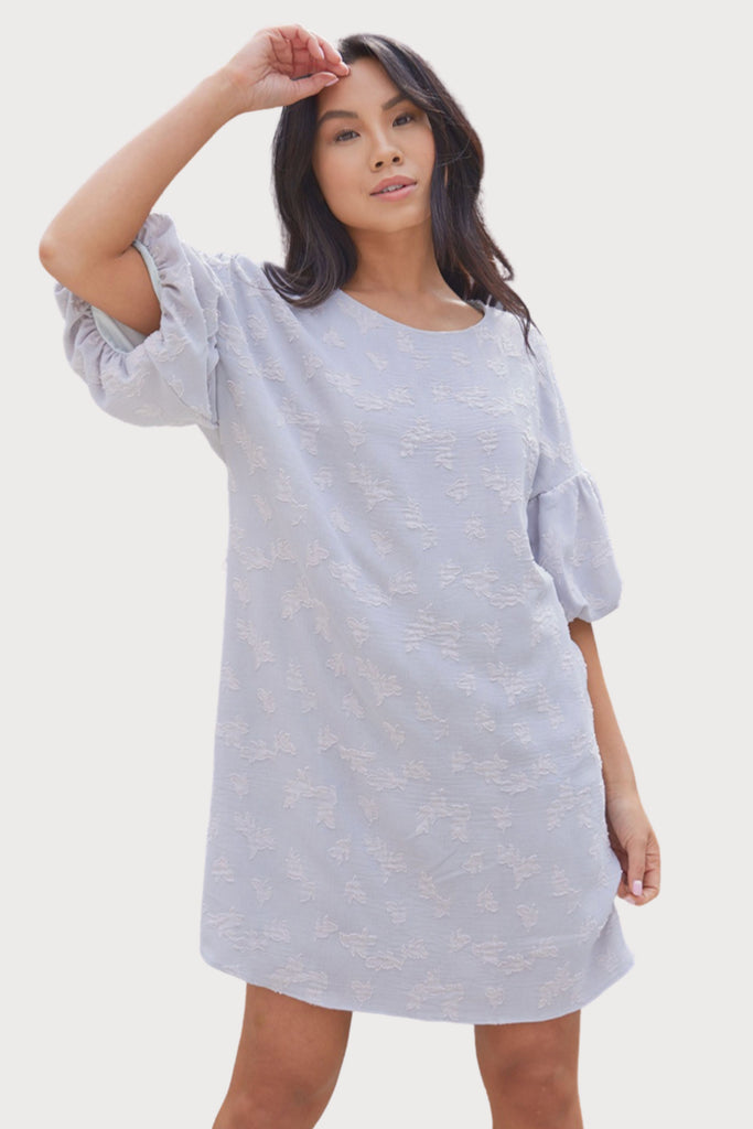 Feminine, flirty, and fun- this stunning dress checks all of the boxes! If you have a special event, date night, or celebration to attend, the Tarah Textured Fabric Dress is a great option! It is stretchy with a very comfortable, lightweight feel. You can wear it looser, or tie the waist for a cinched look. It has elegant balloon sleeves and a unique texture.