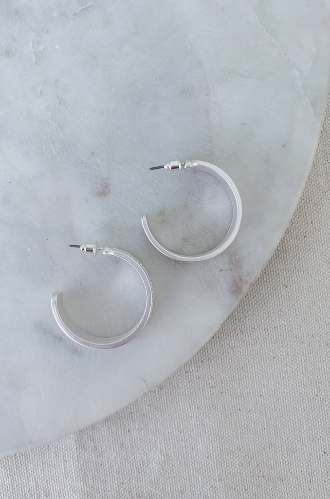 The 1" Aztec Stamped Hoops have a matte finish with a unique design. This style is inspired by the popular western trend we are seeing. They will look cute with any outfit and are comfortable too. 