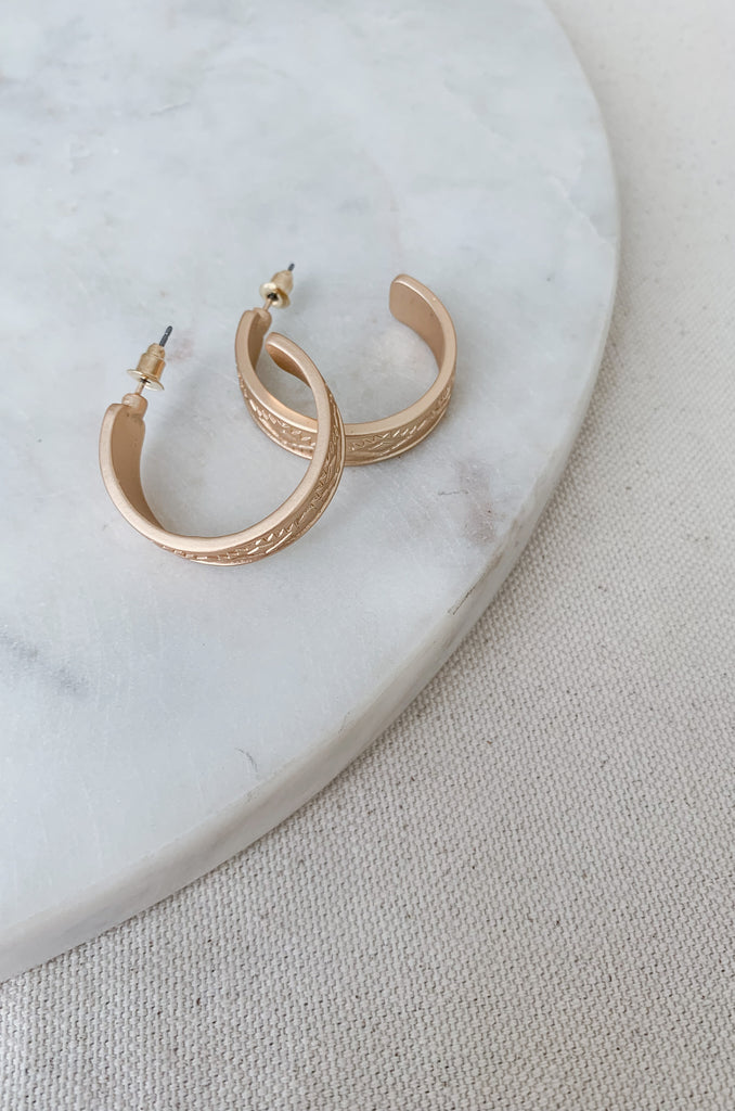 The 1" Aztec Stamped Hoops have a matte finish with a unique design. This style is inspired by the popular western trend we are seeing. They will look cute with any outfit and are comfortable too. 