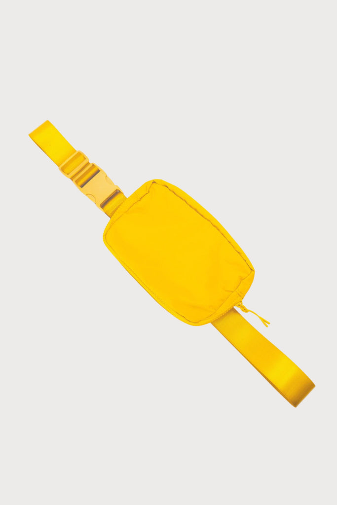 Everyone loves a belt bag for effortless style on the go! This Crossbody Nylon Belt Bag comes in a vibrant yellow with an adjustable strap. The inside is spacious enough to fit your essentials (phone, wallet, keys, etc.) 