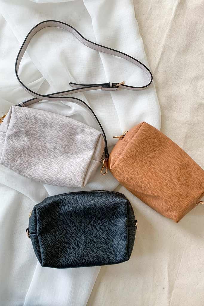 The Girl on the Go Faux Leather Handbag is the perfect pouch for keeping all of your things organized. You can put it in another purse, use it has a cosmetics bag, or wear it on its own. It does come with an adjustable strap to wear as a purse. Choose between three colors: Beige, Black, and Camel. 