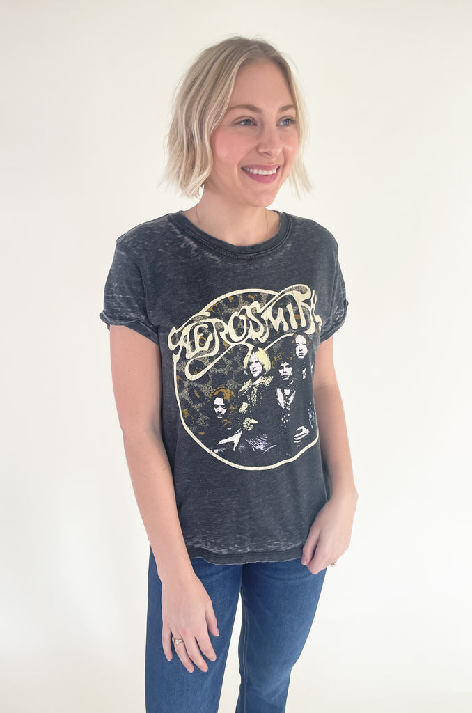 The Aerosmith Back In The Saddle Tee is so comfortable it doesn't even matter how fun it is! But if you love a good band tee, this style is one of the best! It has a cool Aerosmith leopard print graphic on the front and "Back in the Saddle" on the back. Graphic tees are the perfect, cool girl look that's right on trend this season. You will be reaching for it every time you go out, go to a concert, or want to play up your outfit. Try pairing it with our Upgrade Faux Suede Jacket for an easy layering option.