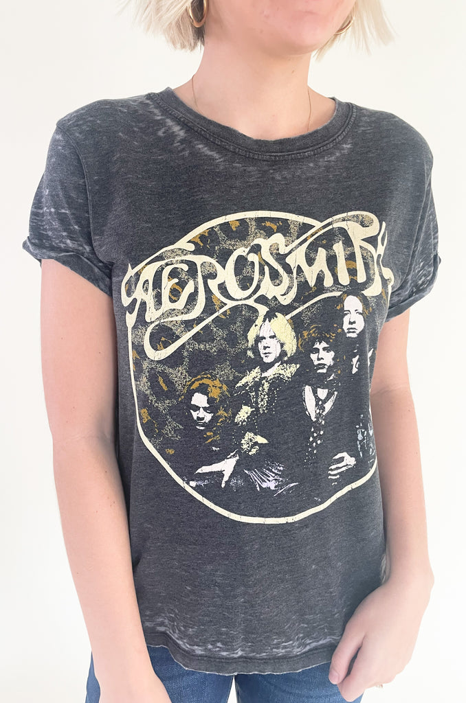The Aerosmith Back In The Saddle Tee is so comfortable it doesn't even matter how fun it is! But if you love a good band tee, this style is one of the best! It has a cool Aerosmith leopard print graphic on the front and "Back in the Saddle" on the back. Graphic tees are the perfect, cool girl look that's right on trend this season. You will be reaching for it every time you go out, go to a concert, or want to play up your outfit. Try pairing it with our Upgrade Faux Suede Jacket for an easy layering option.