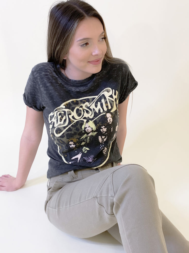 The Aerosmith Back In The Saddle Tee is so comfortable it doesn't even matter how fun it is! But if you love a good band tee, this style is one of the best! It has a cool Aerosmith leopard print graphic on the front and "Back in the Saddle" on the back. Graphic tees are the perfect, cool girl look that's right on trend this season. You will be reaching for it every time you go out, go to a concert, or want to play up your outfit. Try pairing it with our Upgrade Faux Suede Jacket for an easy layering option.