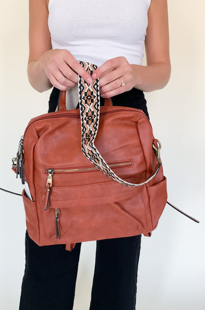 The Amelia Guitar Strap Back Pack is perfect for on-the-go! With multiple interior and exterior pockets, this bag is large enough to fit all the essentials, and more. The faux leather feels really soft and is great quality. The inside is quilted too. Each bag has the traditional faux leather adjustable straps, but also comes with an exclusive guitar strap.