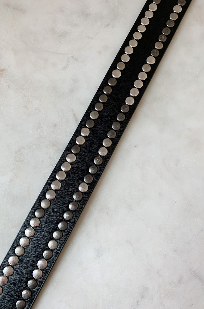 The Black Belt with Silver Mini Dots is 43" long. It is a faux leather belt with multi colored studs. Some are silver while others are more slate great. It is unique with a slightly edgy look. 