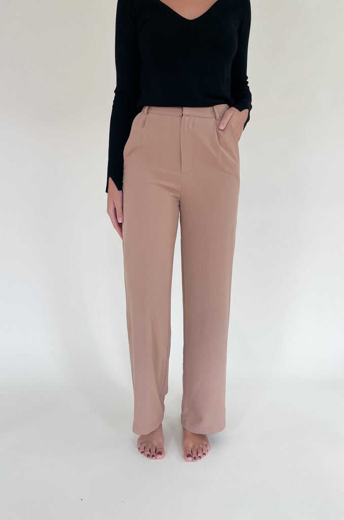 Elevated, lightweight, and comfortable are the qualities we look for in a good pant. The Board Room High Waist Woven Pant is just that and comes in two classic colors: Black and Camel. These wide leg bottoms are perfect for work and special events. They have a zipper fly with a hook enclosure at the top, functional pockets, and belt loops. You cannot go wrong with a staple-piece like quality slacks. 