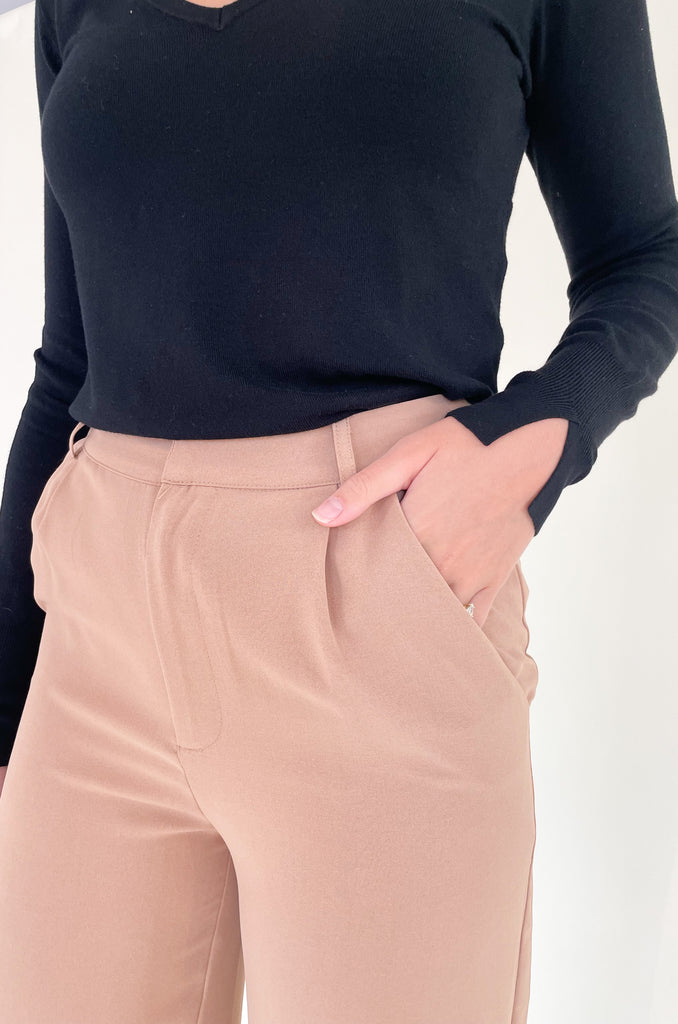 Elevated, lightweight, and comfortable are the qualities we look for in a good pant. The Board Room High Waist Woven Pant is just that and comes in two classic colors: Black and Camel. These wide leg bottoms are perfect for work and special events. They have a zipper fly with a hook enclosure at the top, functional pockets, and belt loops. You cannot go wrong with a staple-piece like quality slacks. 