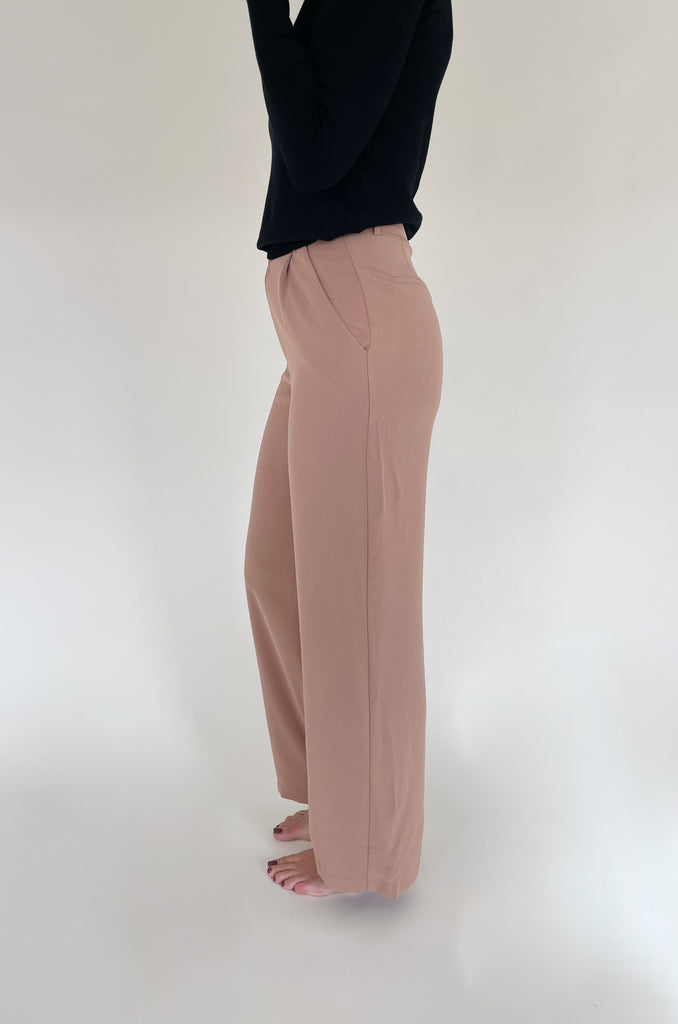 Elevated, lightweight, and comfortable are the qualities we look for in a good pant. The Board Room High Waist Woven Pant is just that and comes in two classic colors: Black and Camel. These wide leg bottoms are perfect for work and special events. They have a zipper fly with a hook enclosure at the top, functional pockets, and belt loops. You cannot go wrong with a staple-piece like quality slacks. 