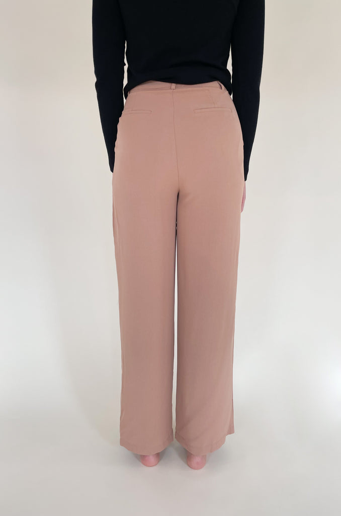 Elevated, lightweight, and comfortable are the qualities we look for in a good pant. The Board Room High Waist Woven Pant is just that and comes in two classic colors: Black and Camel. These wide leg bottoms are perfect for work and special events. They have a zipper fly with a hook enclosure at the top, functional pockets, and belt loops. You cannot go wrong with a staple-piece like quality slacks. 