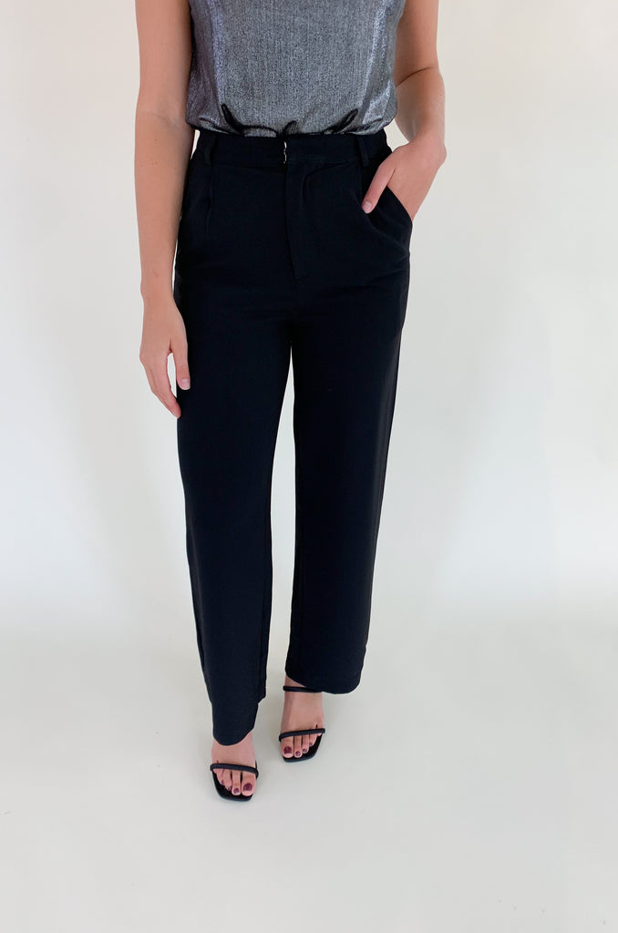 Elevated, lightweight, and comfortable are the qualities we look for in a good pant. The Board Room High Waist Woven Pant is just that and comes in two classic colors: Black and Camel. These wide leg bottoms are perfect for work and special events. They have a zipper fly with a hook enclosure at the top, functional pockets, and belt loops. You cannot go wrong with a staple-piece like quality slacks. 