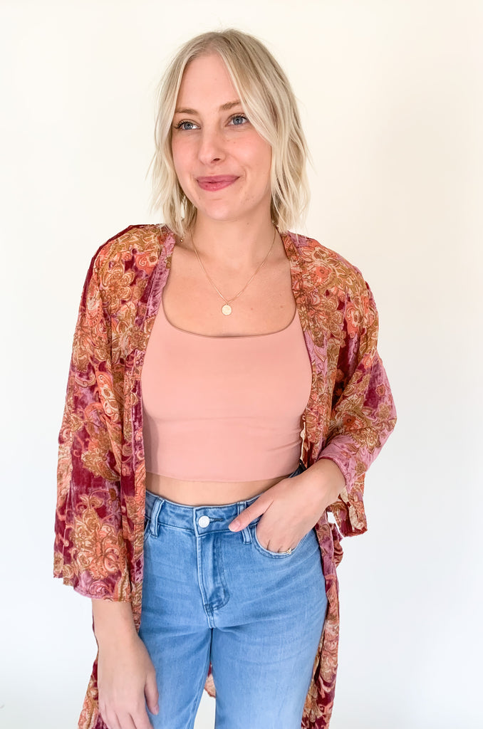 The Desert Rose Velvet Burnout Kimono is absolutely stunning. It is elegant with rich colors and soft textures. The fabric is fairly lightweight, but the hint of velvet speaks to fall fashion. We are obsessed with the mauve and burgundy hues combined with the floral print. You can layer it over so many looks too. It's a must-have!