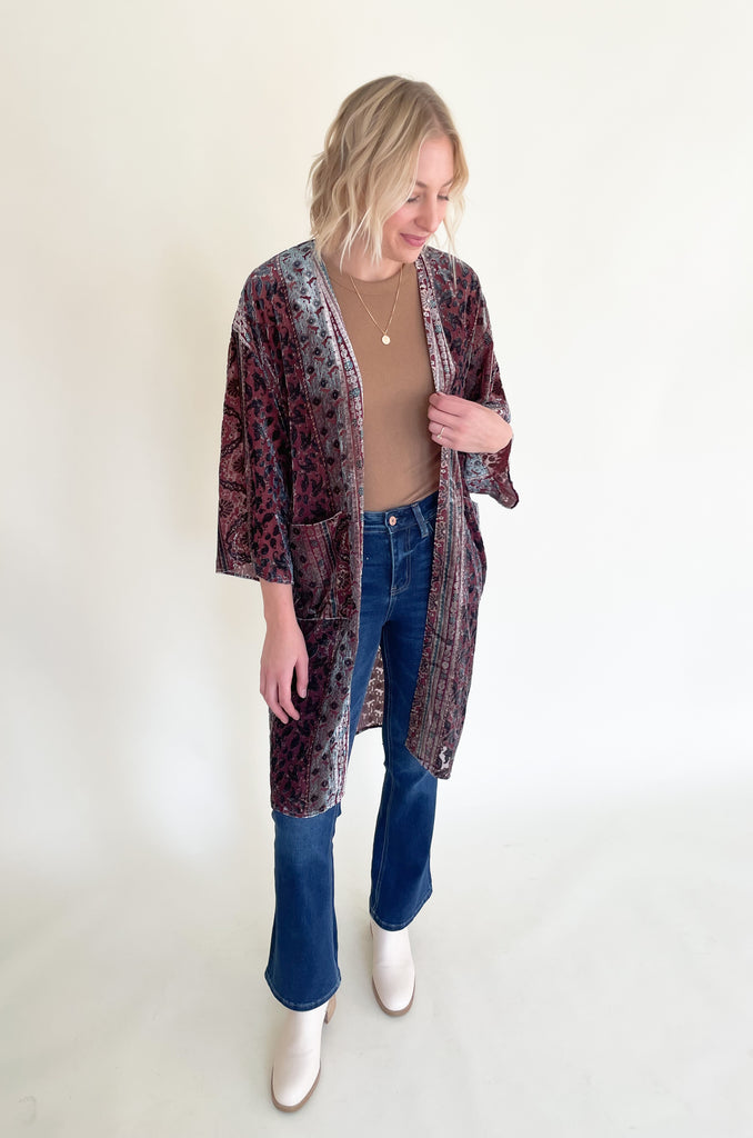 The Budapest Velvet Burnout Kimono is absolutely stunning. It is elegant with rich colors and soft textures. The fabric is fairly lightweight, but the hint of velvet speaks to fall fashion. We are obsessed with the deep jewel-toned hues combined with a vintage floral print. You can layer this kimono over so many looks too. It's a must-have!