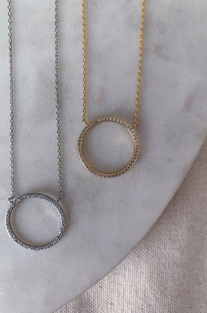 The CZ Medium Circle Necklace is a go to necklace for all seasons. You can wear it to work, school, shopping, or anywhere! This necklace can add some shimmer to any outfit, and is a great choice! 