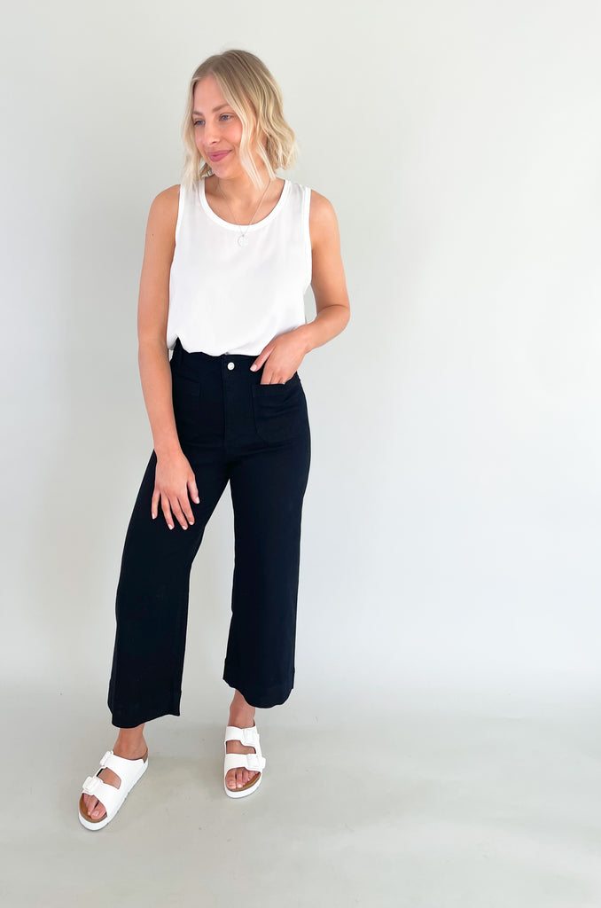 high rise colored wide leg pants with front pockets. This jean comes in pink, black, and off-white
