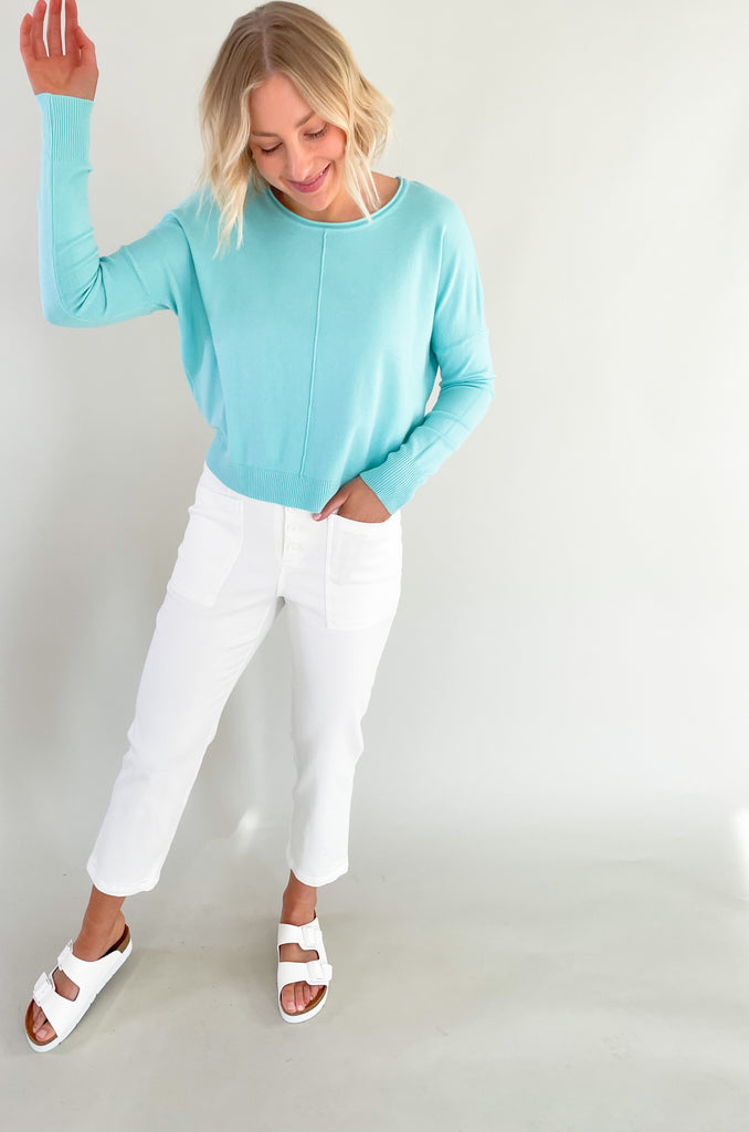 round neck, center seam sweater with soft stretchy fabric made by Dreamers. Semi-cropped with slits at the sides