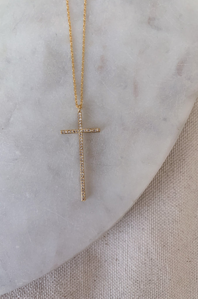 The Dainty Large Cross CZ Necklaces are a great everyday, all year necklace. This necklaces has a beautiful long studded dainty cross. The adjustable chain allows for easy layering, or a great gift. These lightweight necklaces come in silver or gold.