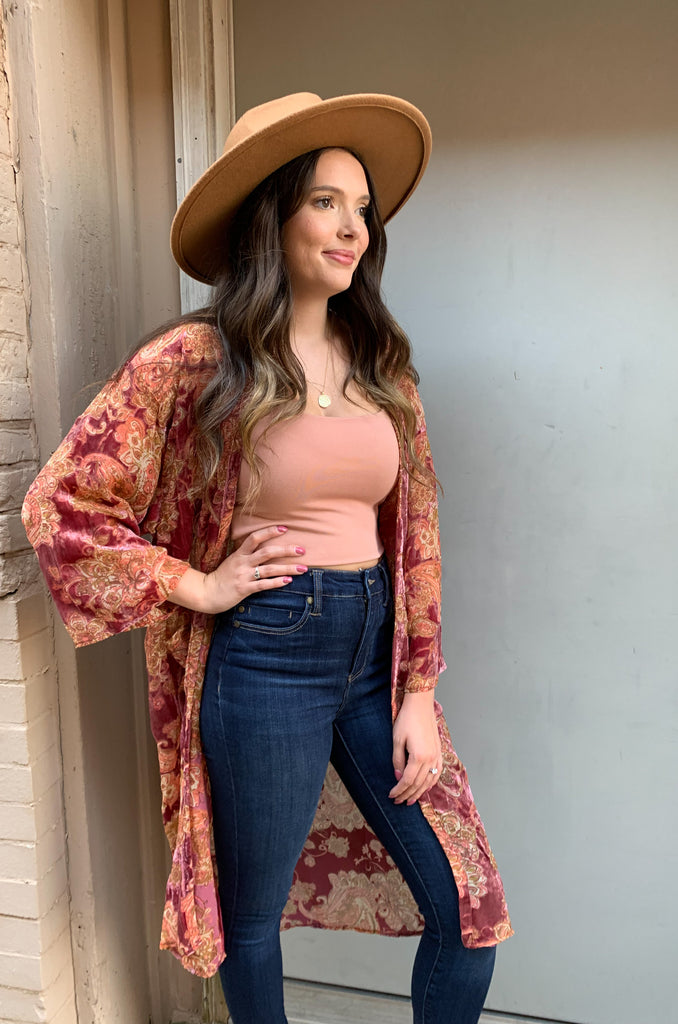 The Desert Rose Velvet Burnout Kimono is absolutely stunning. It is elegant with rich colors and soft textures. The fabric is fairly lightweight, but the hint of velvet speaks to fall fashion. We are obsessed with the mauve and burgundy hues combined with the floral print. You can layer it over so many looks too. It's a must-have!