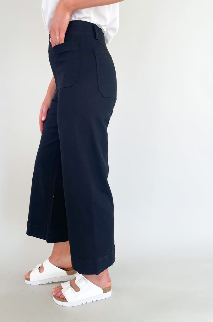 high rise colored wide leg pants with front pockets. This jean comes in pink, black, and off-white