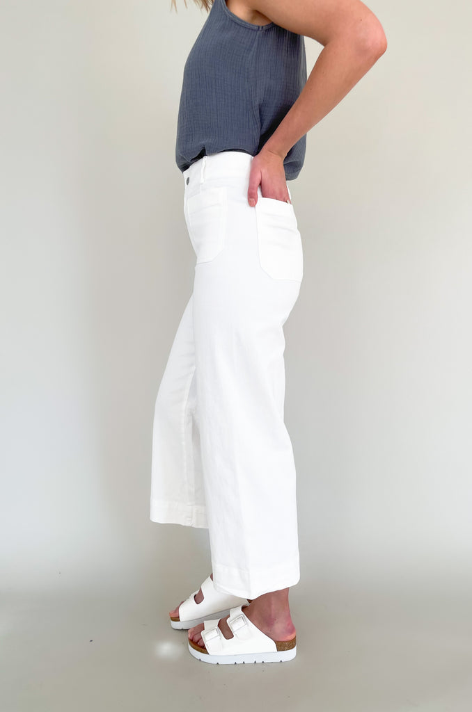 high rise colored wide leg pants with front pockets. This jean comes in pink, black, and off-white