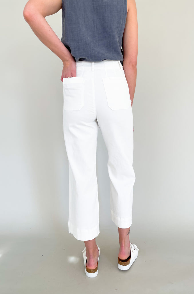 high rise colored wide leg pants with front pockets. This jean comes in pink, black, and off-white