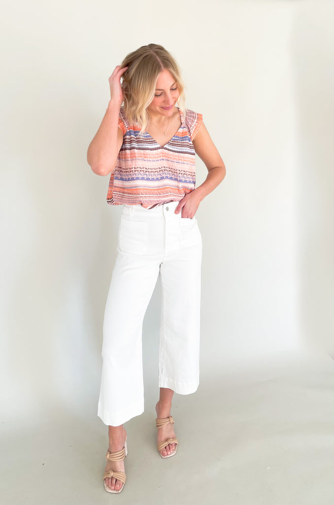 high rise colored wide leg pants with front pockets. This jean comes in pink, black, and off-white