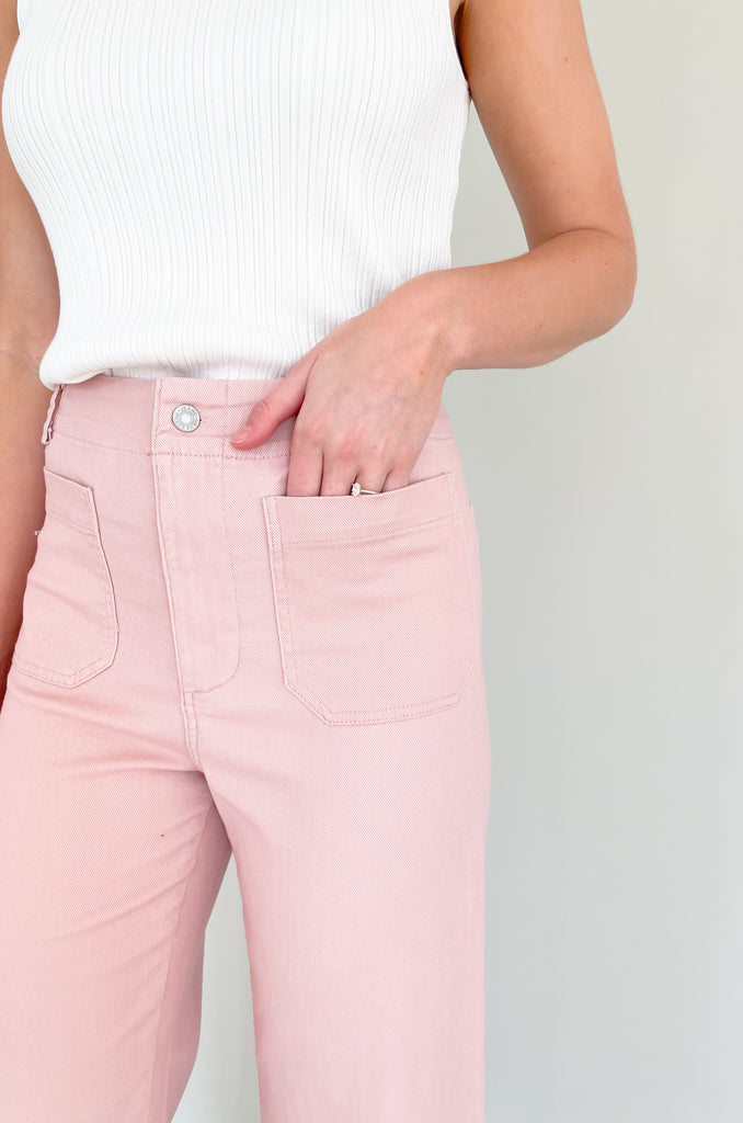 high rise colored wide leg pants with front pockets. This jean comes in pink, black, and off-white