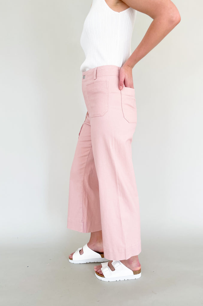 high rise colored wide leg pants with front pockets. This jean comes in pink, black, and off-white