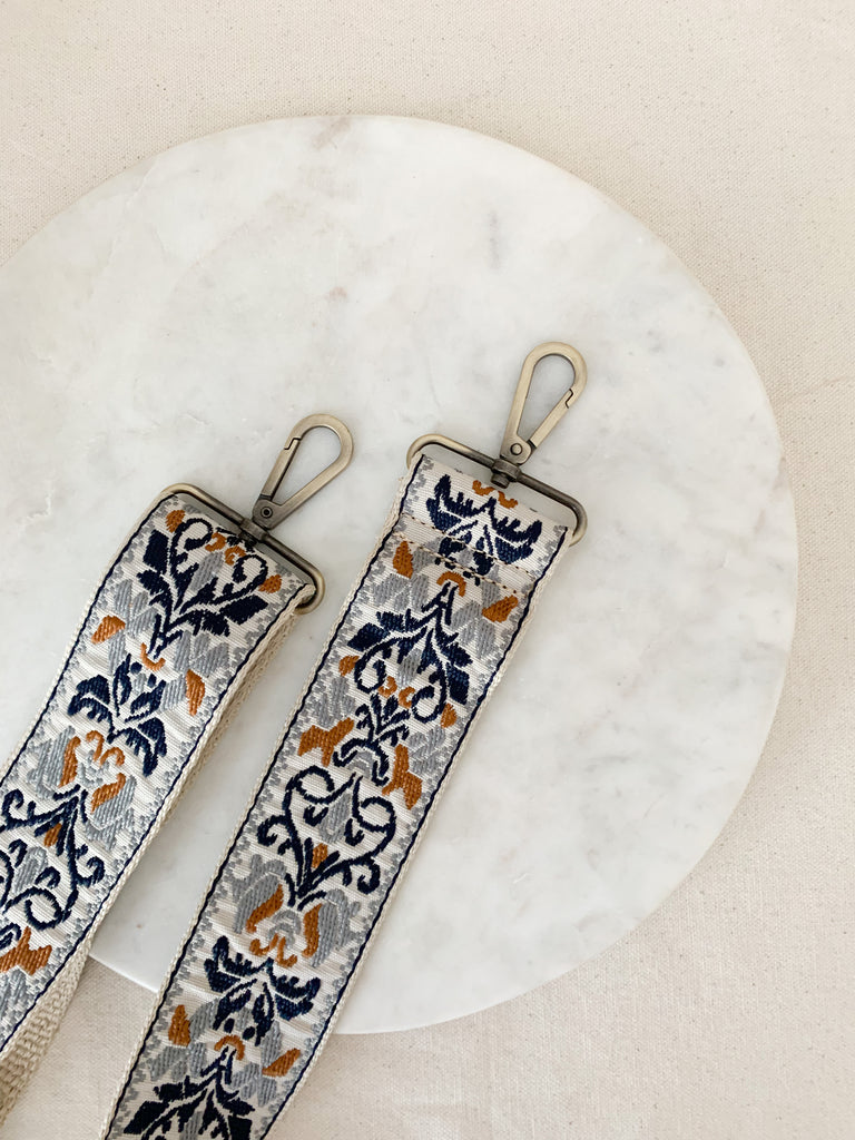 Make your favorite bag pop with these amazing Fabric Guitar Straps! They are so pretty and a very trendy. Each one is unique and durable. You can detach it an add it to any bag. At each end, there are gold tone metal clasps. 