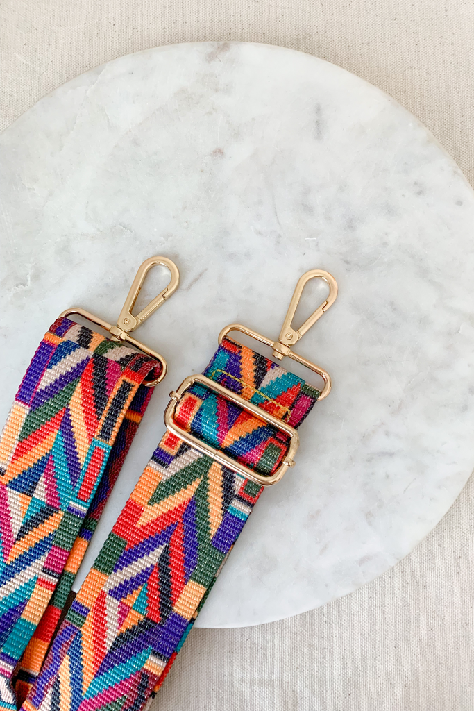 Make your favorite bag pop with these amazing Fabric Guitar Straps! They are so pretty and a very trendy. Each one is unique and durable. You can detach it an add it to any bag. At each end, there are gold tone metal clasps. 