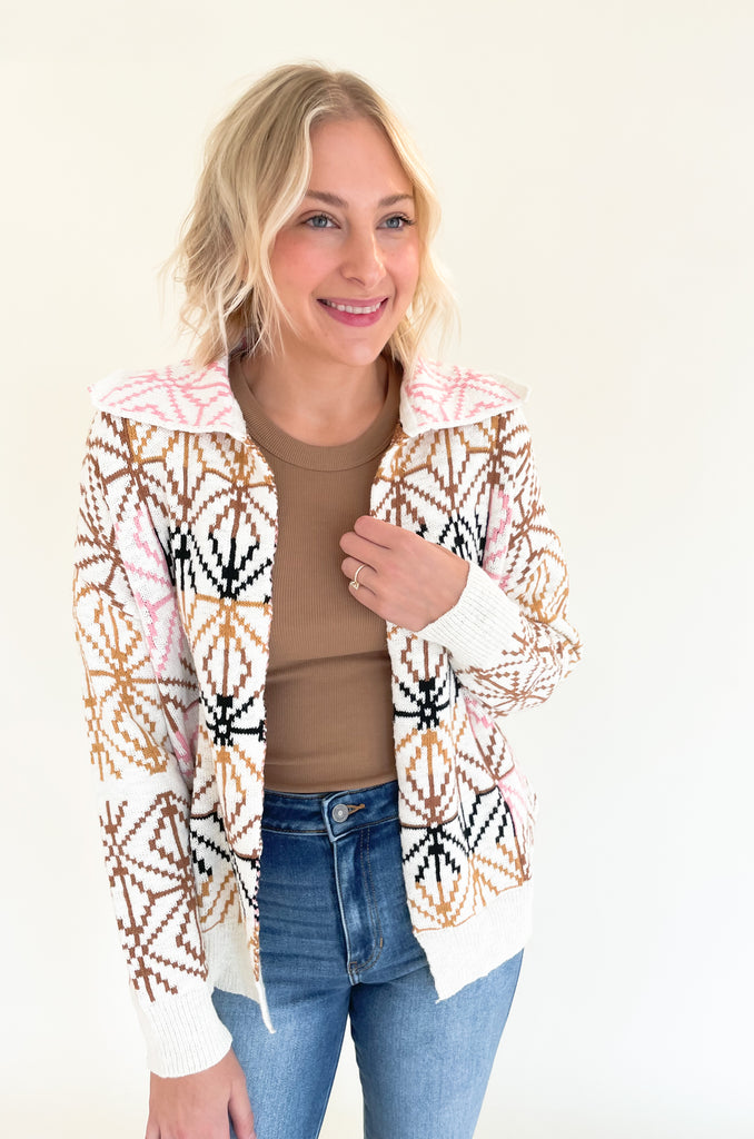 If you are looking for a unique statement piece, the Geometric Pattern Collared Cardigan is a winner! It has a trendy shape with an open front and defined collar. All over the cardigan is a unique brown, blush pink, and black geometric design. It  is a special style that looks chic and effortless. You can pair it over so many styles too, like our Joanie Tanks and Mae Tees.