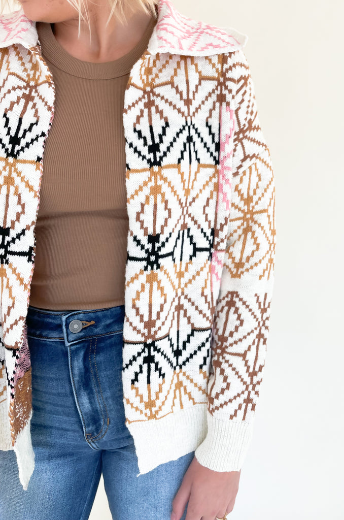 If you are looking for a unique statement piece, the Geometric Pattern Collared Cardigan is a winner! It has a trendy shape with an open front and defined collar. All over the cardigan is a unique brown, blush pink, and black geometric design. It  is a special style that looks chic and effortless. You can pair it over so many styles too, like our Joanie Tanks and Mae Tees.