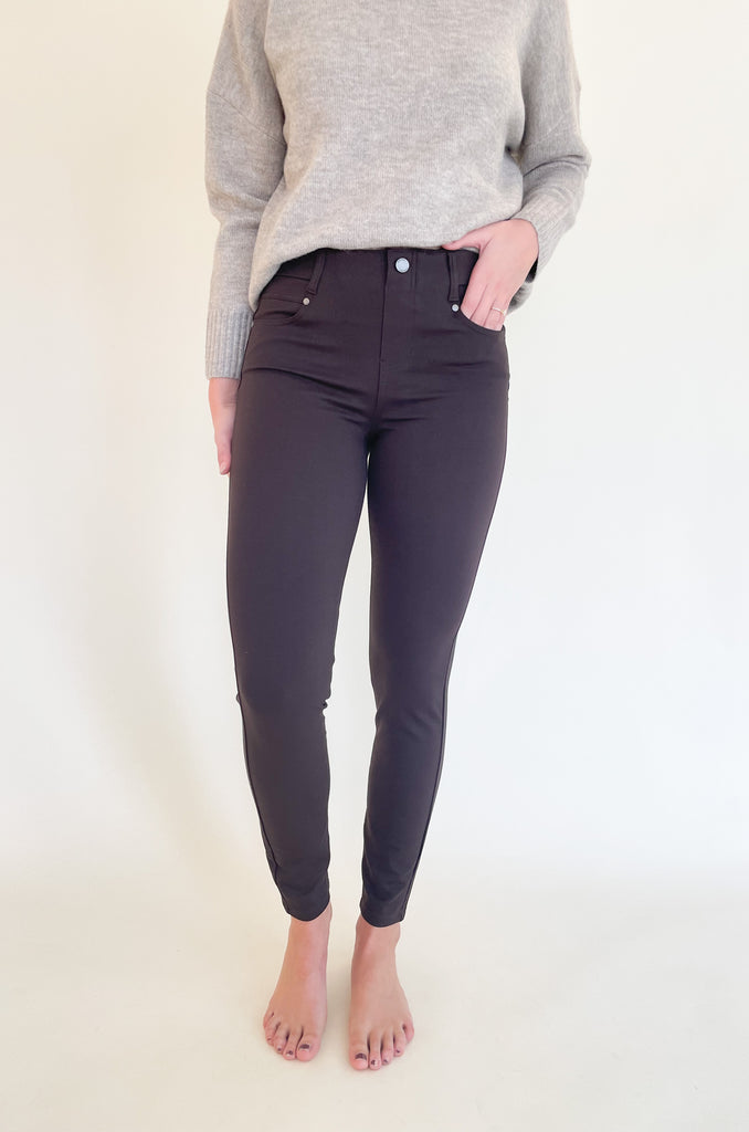 The Gia Glider Pull On Ankle Pants 30" are a deep java color, perfect for fall and winter.    They are a pull on elastic pant built for comfort. Soft and stretchy doesn't even begin to describe how amazing these pants are! It does not have a zipper, which makes the style look streamlined. You can wear these pants with any top, blouse, or sweater. They will instantly elevate the look! 