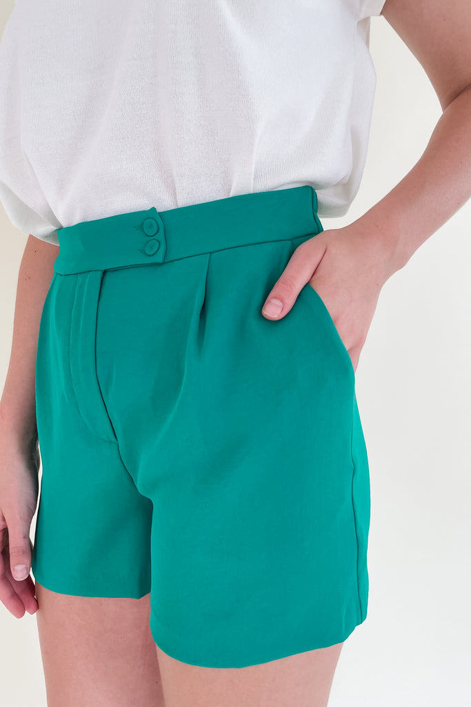 The Heidi Tailored Elastic Back Shorts are so fun! The pops of color are so trendy right now. Plus, the fabric is so elevated. It has an elastic waist band, pockets, a zipper fly, and pleats. It also has two buttons on the front. 