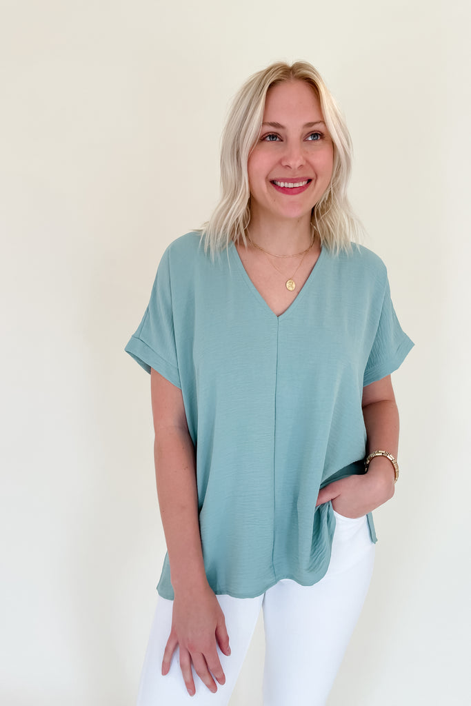 The Jamie V Neck Center Seam Blouse is a lightweight blouse that can be dressed up or down for any occasion! This soft V-neck top has a cuffed sleeves that can be worn year around. This is a great basic to add to your closet!