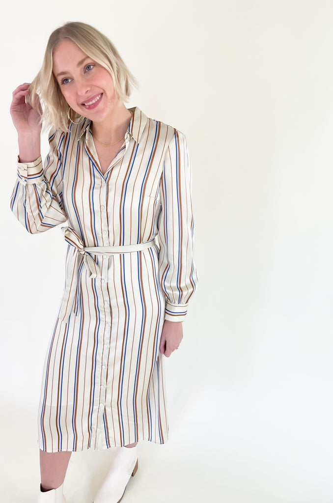 The Jump Back Stripe Long Sleeve Dress is such a gorgeous style that can be worn all year. The fabric is an elevated silk-like material that feels luxurious. We love the button up style with the waist belt. It is flattering on several body types and effortless! Plus, the colors are fun and timeless. 