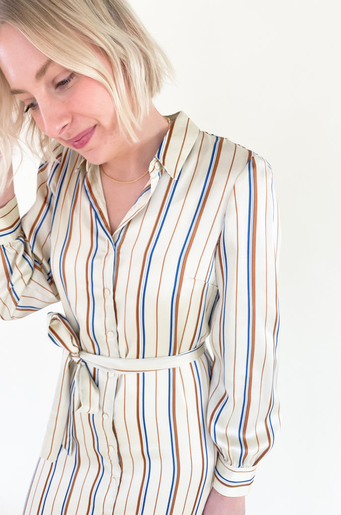 The Jump Back Stripe Long Sleeve Dress is such a gorgeous style that can be worn all year. The fabric is an elevated silk-like material that feels luxurious. We love the button up style with the waist belt. It is flattering on several body types and effortless! Plus, the colors are fun and timeless. 
