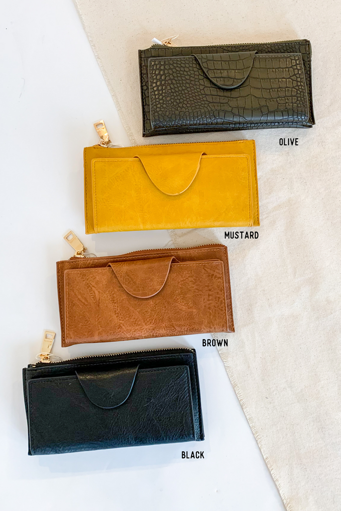 The Kyla Wristlet Strap Wallet is so chic and easy to take anywhere! It is big enough to carry everything you need and has a wristlet band for on the go.  The Kyla Wallet is Vegan Leather and very durable. We love it! Choose between several colors to go with any of our new handbags.