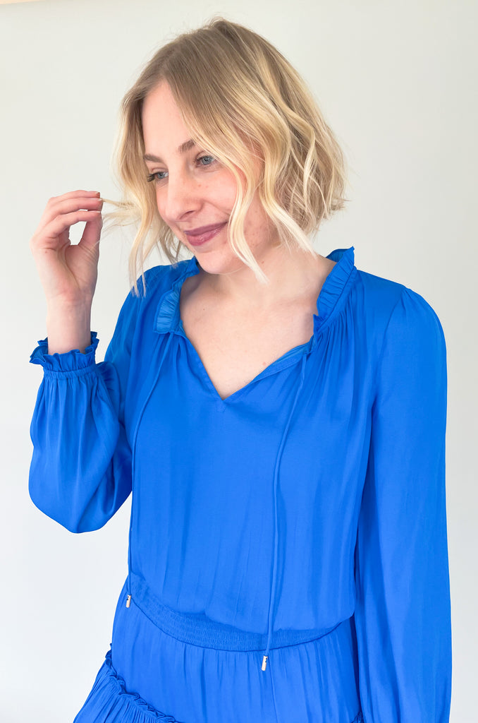 The Long Sleeve Ruffle Party Dress is a "WOW" piece! That bright cobalt blue color makes a statement, along with the other stunning details on this dress. The fabric is silky and elevated. It has long sleeves that helps balance the above the knee length. With the tiered shape, it gives a flattering flounce too. This style is a go-to for special events!