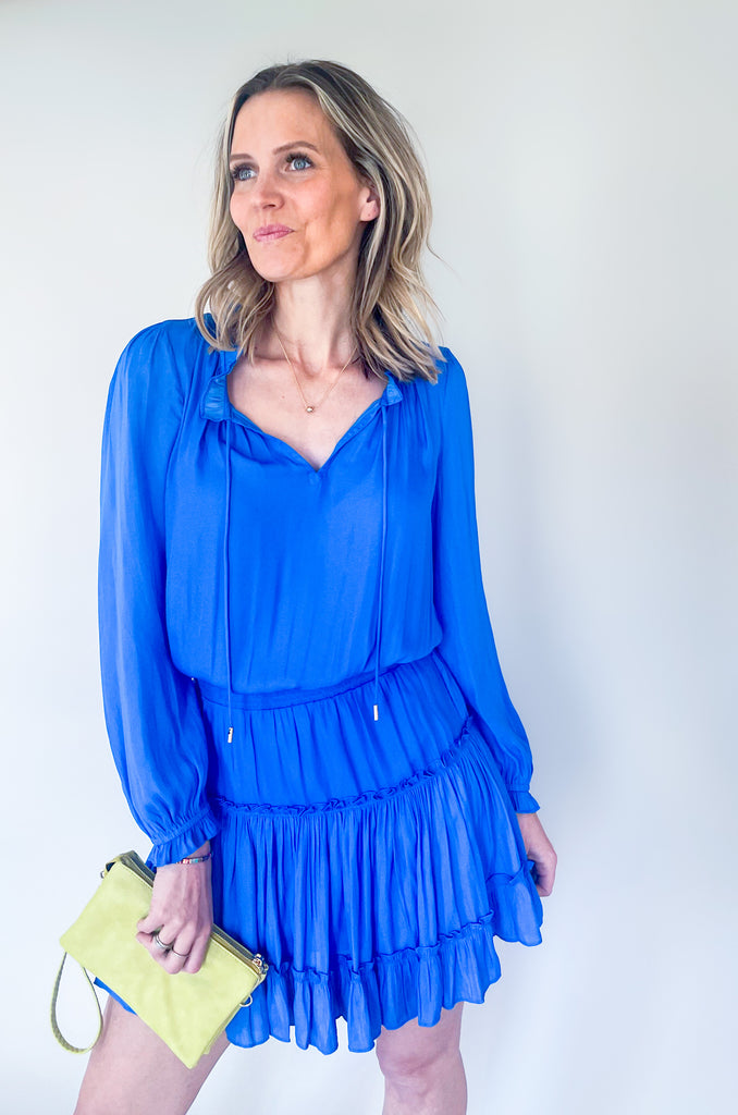 The Long Sleeve Ruffle Party Dress is a "WOW" piece! That bright cobalt blue color makes a statement, along with the other stunning details on this dress. The fabric is silky and elevated. It has long sleeves that helps balance the above the knee length. With the tiered shape, it gives a flattering flounce too. This style is a go-to for special events!