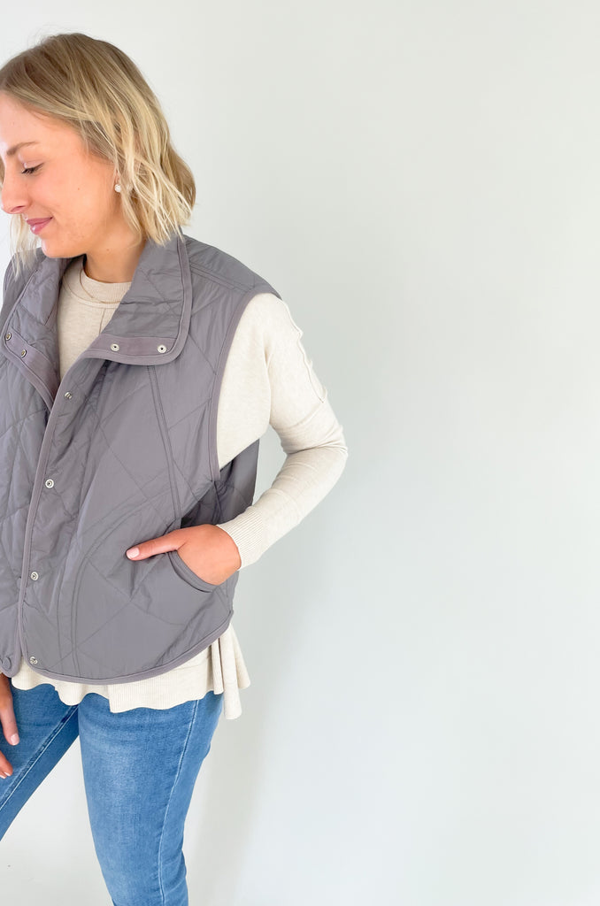 Pewter or sage snap button quilted vest. It's lightweight and perfect for spring layering!