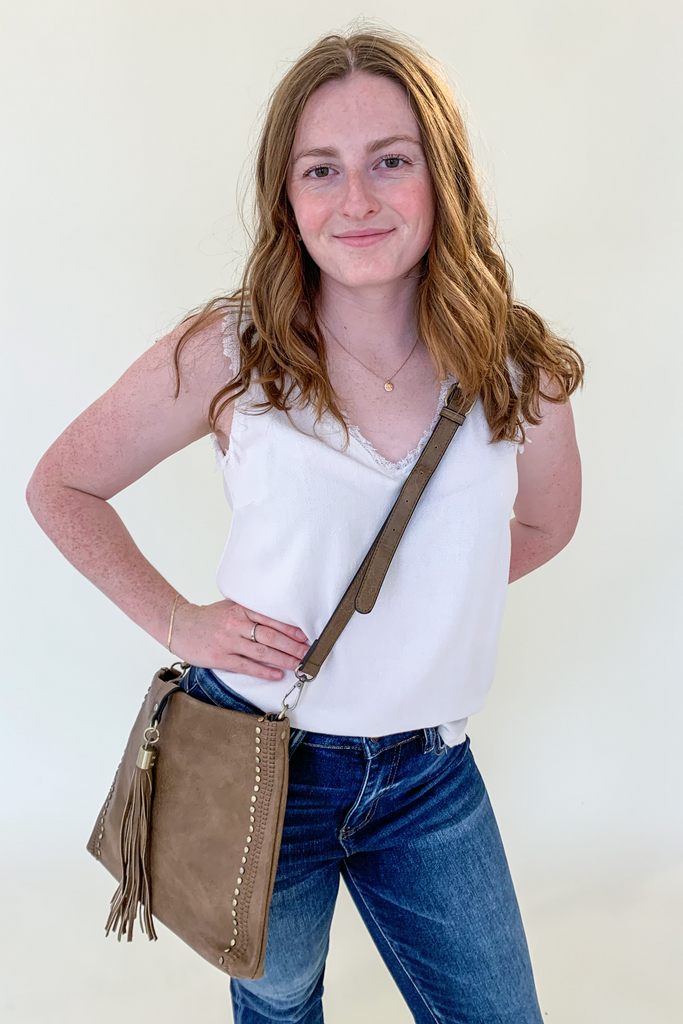 The Mary Tassel Foldover Crossbody is a trendy style that features a foldover long tassel and studded details. We are obsessing over its soft taupe color. It will look great with everything!